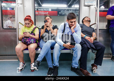 Barcelona Spain,Catalonia Catalunya,Transports Metropolitans de Barcelona TMB,metro,subway,rapid transit,train,passengers commuters riders,sitting sea Stock Photo