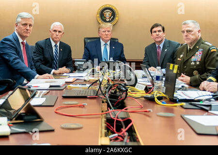 Washington DC, USA. 27th Oct, 2019. President Donald J. Trump is pictured in the Situation Room of the White House on October 26, 2019, monitoring developments as U.S. Special Operations forces conduct a capture or kill mission in Syria against ISIS leader Abu Bakr al-Baghdadi. Vice President Mike Pence, along with National Security Advisor Robert O'Brien, left; Secretary of Defense Mark Esper and Chairman of the Joint Chiefs of Staff U.S. Army General Mark A. Milley, right, were all present at the time. Trump later confirmed that the ISIS leader was killed along with others during a two-hour  Stock Photo