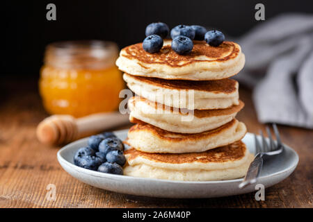 Stack of pancakes with blueberries on a wooden table. Tasty breakfast buttermilk pancakes, american cuisine Stock Photo