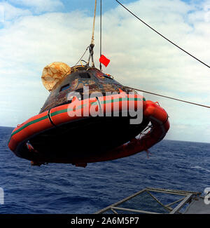 The Apollo 11 Command Module is hoisted aboard the USS Hornet, the prime recovery vessel for the historic Apollo 11 lunar landing mission. The splashdown took place at 12:49 p.m. ET, July 24, 1969, about 812 nautical miles southwest of Hawaii, only 12 nautical miles from the USS Hornet. Stock Photo