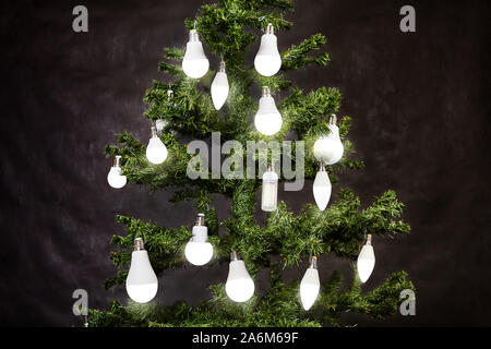 Light-emitting diode or led lamps hanging on christmas tree. White matte energy-efficient, energy saving and eco friendly electric lamp shine on a New Stock Photo