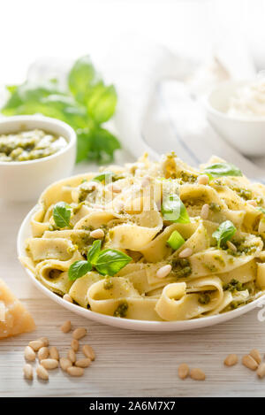 Large portion of noodles with fresh basil pesto and pine nuts Stock Photo