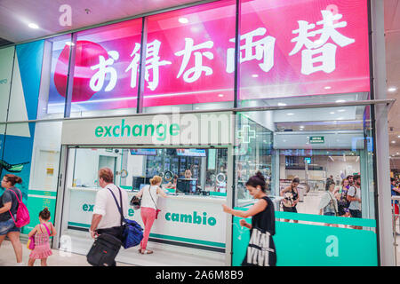 Barcelona Spain,Catalonia Barcelona-Sants Renfe train station,currency exchange office,man,woman,inside interior,riders passengers commuters,Japanese Stock Photo