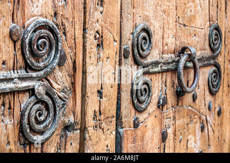 Barcelona Spain,Catalonia Monastery of Pedralbes,Gothic historic complex,ancient door,antique iron door hardware,door knocker,aged weathered wood,ES19 Stock Photo
