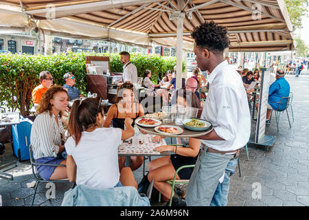 Barcelona Spain,Catalonia Passeig de Gracia,shopping dining district,sidewalk cafe, restaurant,al fresco dining,waiter serving server,carrying tray,fo Stock Photo