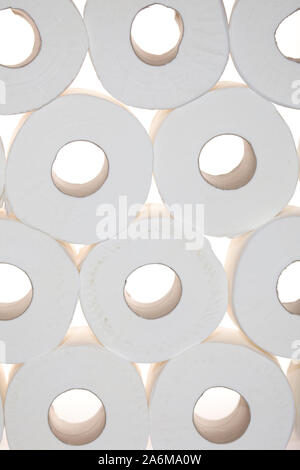 Toilet rolls piled up on white background Stock Photo