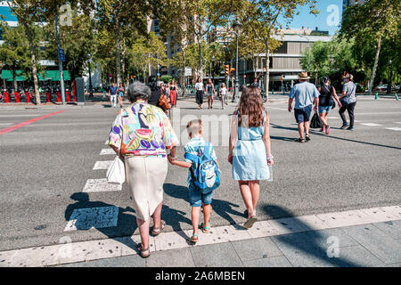 Barcelona Spain,Catalonia Les Corts,Avinguda Diagonal,crossing street,woman,girl,boy,grandmother,grandchild,walking,holding hand,family,Hispanic,ES190 Stock Photo