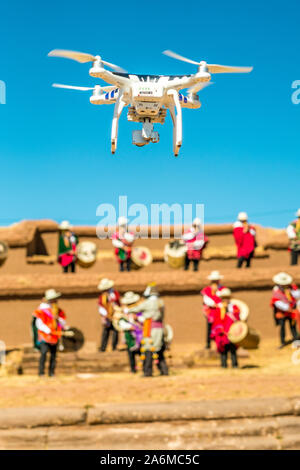 La Paz, Bolivia; September 12, 2016: Drone Quadracopter Filming a Traditional Bolivian Indigenous Musical Band on Infamous Tiwanaku Tiwanacota Temple Stock Photo