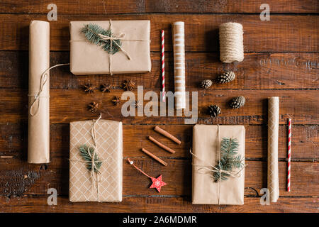 Top view of wrapped giftboxes and other Christmas stuff on wooden table