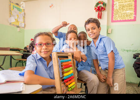 Santo Domingo, La Altagracia / Dominican Republic - April 11 2014: Group of Children Laughing Behind a Girl Who Holds an Abacus in a Classroom at Scho Stock Photo