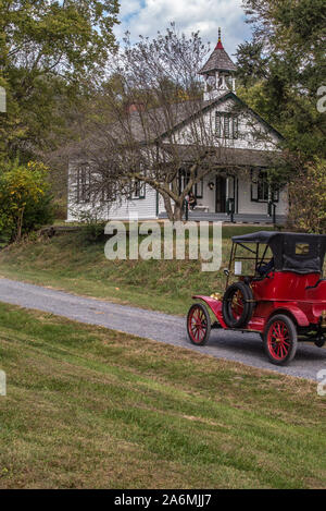 Antique cars on school house dirt road, Landis Valley farm museum, Lancaster, PA. Stock Photo
