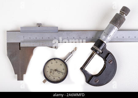 Caliper, micrometer and sensor. Measuring tools used in the workshop. Light background. Stock Photo