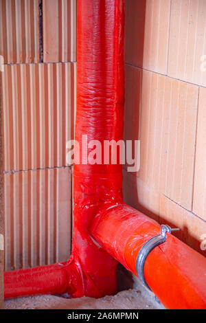 Soundproofed drain pipe in a house which is under construction Stock Photo