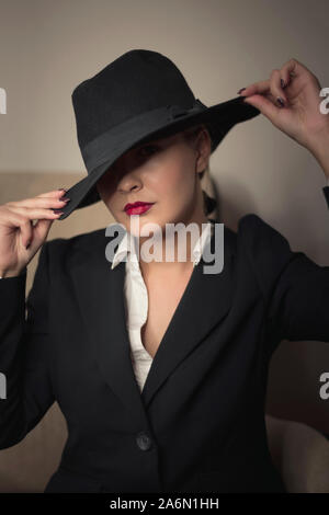 Young woman in black clothes with hat portrait Stock Photo