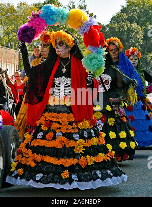 Emporia, Kansas, USA, October 26, 2019 Day of the Dead (Dia de los Muertos)  celebration held in Emporia today. Women in traditional La Calavera Catrina outfit with Mexican Marigolds hat and sugar skull face make up in parade today. Stock Photo