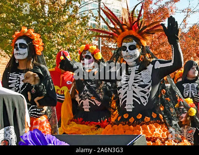 Emporia, Kansas, USA, October 26, 2019 Day of the Dead (Dia de los Muertos)  celebration held in Emporia today. Man in traditional La Calavera Catrin  outfit with Mexican Marigolds and feather hat