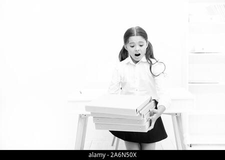 oh no. kid learn and study hard. back to school. shocked girl with workbook folders. Education. heavy documents. Towards knowledge. small girl in school uniform. lot of homework. Get information. Stock Photo