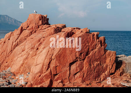 ARBATAX, ITALY / OCTOBER 2019: The scenic red rocks beach in Sardinia, Ogliastra region Stock Photo