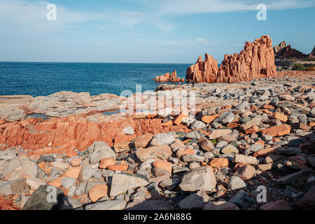 ARBATAX, ITALY / OCTOBER 2019: The scenic red rocks beach in Sardinia, Ogliastra region Stock Photo