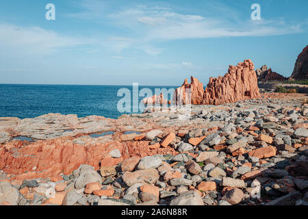 ARBATAX, ITALY / OCTOBER 2019: The scenic red rocks beach in Sardinia, Ogliastra region Stock Photo