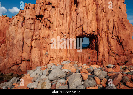 ARBATAX, ITALY / OCTOBER 2019: The scenic red rocks beach in Sardinia, Ogliastra region Stock Photo