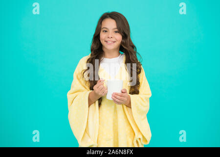 Health Benefits of Drinking Milk Before Bed. Little child hold mug. Girl in pajamas drinking tea. Relaxation before sleep. Drinking milk just before heading to bed. Bedtime Beverages. Evening routine. Stock Photo