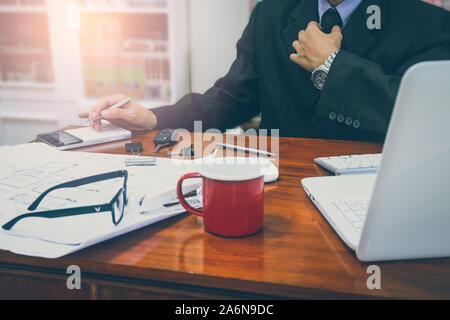 Businessman or accountant working on calculator to calculate business data concept. Accounting,investment advisor consulting situation on the financia Stock Photo