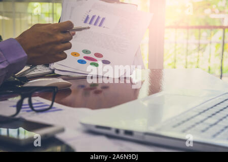 Businessman or accountant working on calculator to calculate business data concept. Accounting,investment advisor consulting situation on the financia Stock Photo