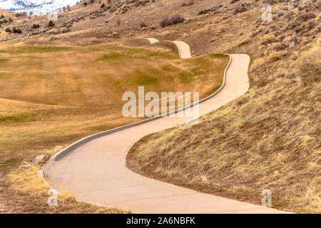 Winding narrow rural road through foothills golf Stock Photo