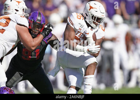 Texas Longhorns running back Keaontay Ingram (26) is stopped behind the  line by Oklahoma defensive lineman Kenneth Mann (55) during the Dr. Pepper  Big-12 Championship between the Oklahoma Sooners vs Texas Longhorns