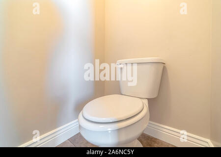 White toilet and cistern in a bathroom Stock Photo