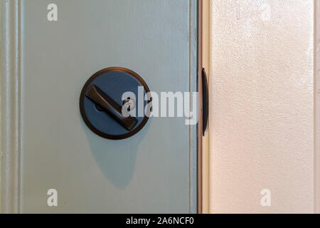 Close up of unlocked deadbolt latch on home door Stock Photo