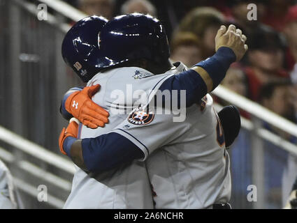 Houston Astros fan Mark McKee, of Beaumont, Texas, celebrates as he watches  the Astros' Yuli Gurriel (10) congratulate Yordan Alvarez (44) on his  two-run home run as umpire Larry Vanover stands by