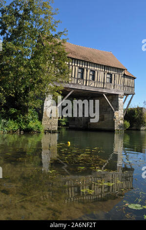 Built in the 16th century, the landmark Old Mill in Vernon, France sits atop the ruins of a historic bridge spanning the Seine River. Stock Photo