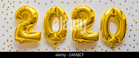 Foil balloons golden color in the form of numbers 2020. New year celebration, christmas, xmas. Flat lay with Air Balloons, top view, mockup, overhead Stock Photo