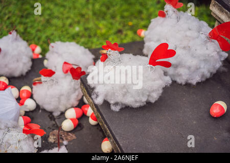 Chicken and red eggs on the lawn Stock Photo