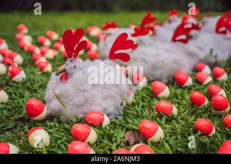 Chicken and red eggs on the lawn Stock Photo