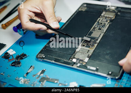 Close-up image of professional repairman assembling digital tablet Stock Photo