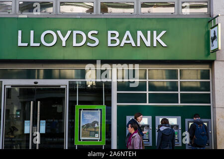 People walk past a branch of Lloyds Bank in central London. Stock Photo