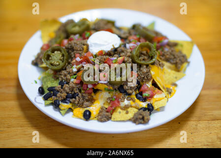 Mexican Nacho Chips Served On Wooden Table Stock Photo