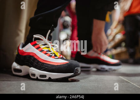 Person tying shoelaces on sneakers Stock Photo