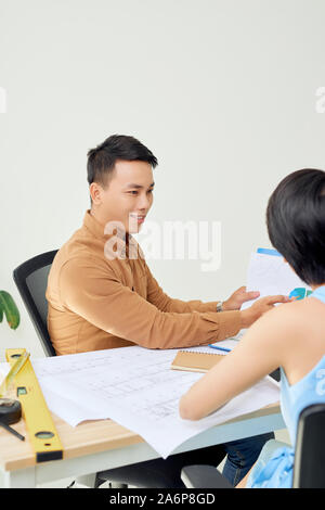 Cheerful two architects are discussing new project Stock Photo