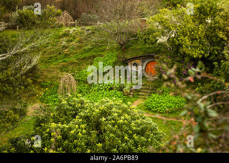 Hobbit hole tucked under a hill in the Hobbiton Movie Set, Matamata, New Zealand