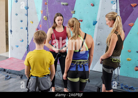 Young climbing instructor consulting group of active young people Stock Photo