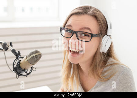 Radio, blogging, broadcast concept - close-up of woman dj is working on the radio Stock Photo