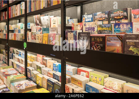 Books on shelf in bookstore, Dalian, China 13-06-19 Stock Photo