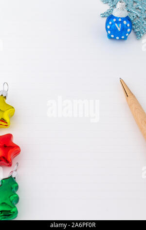 a vertical white background with New Year decorations and a wooden pen Stock Photo
