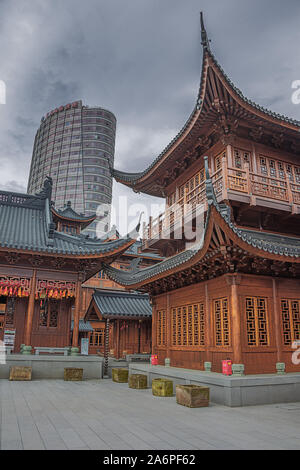 Editorial: SHANGHAI, CHINA, April 16, 2019 - The classical Jade Buddha Temple with modern skyscraper in Shanghai Stock Photo