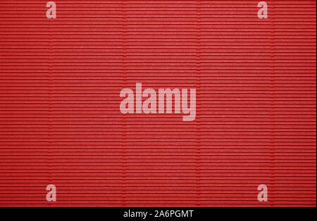 Close up background pattern texture of vivid scarlet red corrugated packaging cardboard Stock Photo