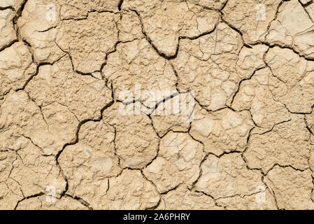 Clay sandy earth parched and cracked Stock Photo